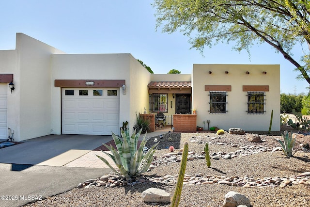 pueblo-style house featuring a garage