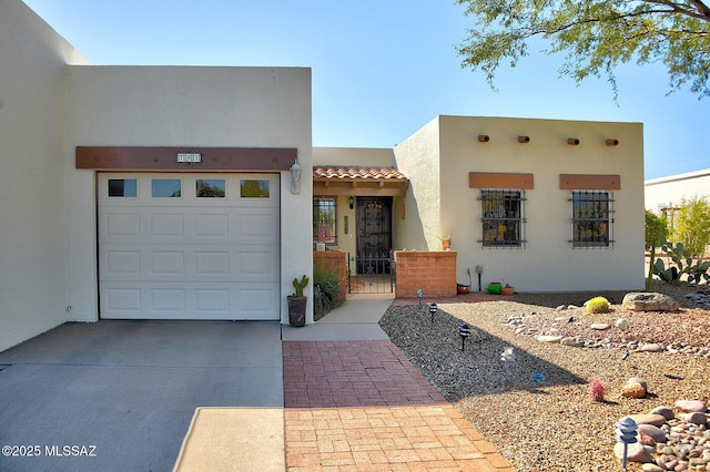 pueblo-style home with a garage