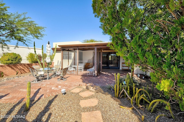 rear view of property featuring a patio