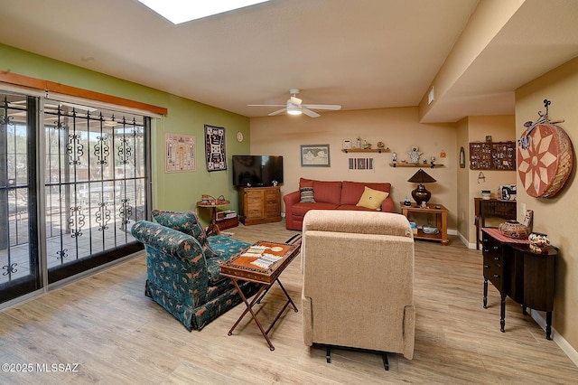 living room featuring ceiling fan and hardwood / wood-style flooring