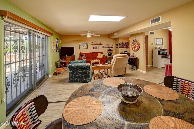 dining area featuring ceiling fan and light hardwood / wood-style flooring