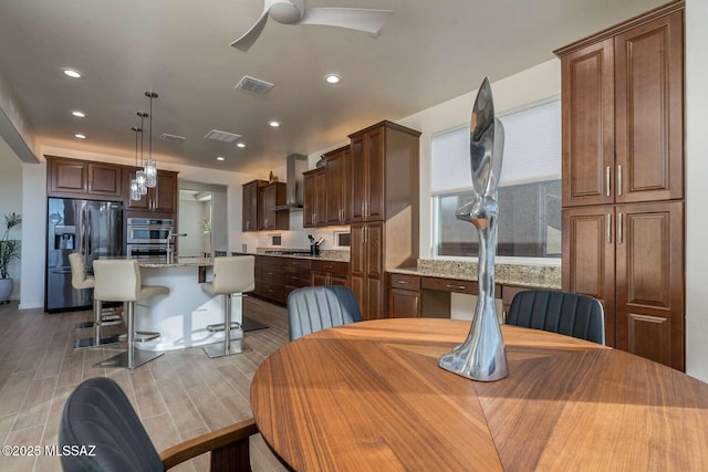 dining room featuring wood finish floors, visible vents, ceiling fan, and recessed lighting