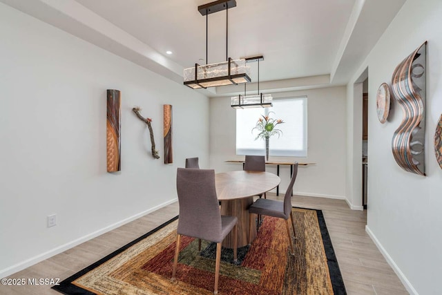 dining area with light wood finished floors, baseboards, and recessed lighting