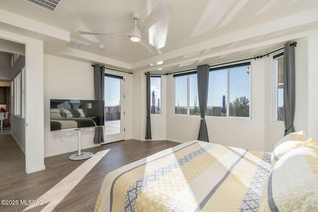 bedroom featuring access to exterior, baseboards, visible vents, and wood finished floors