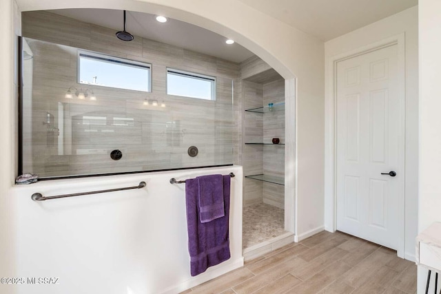 bathroom with walk in shower, wood finished floors, and recessed lighting