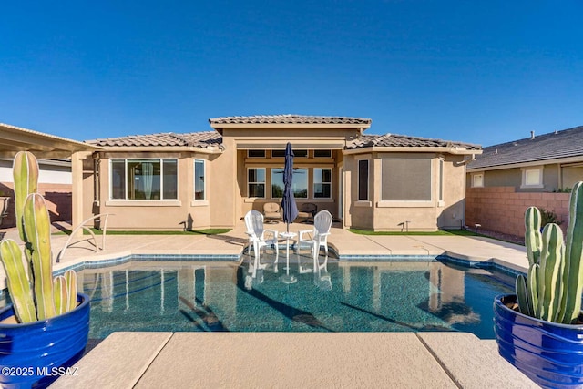 view of swimming pool with a patio area, fence, and a fenced in pool