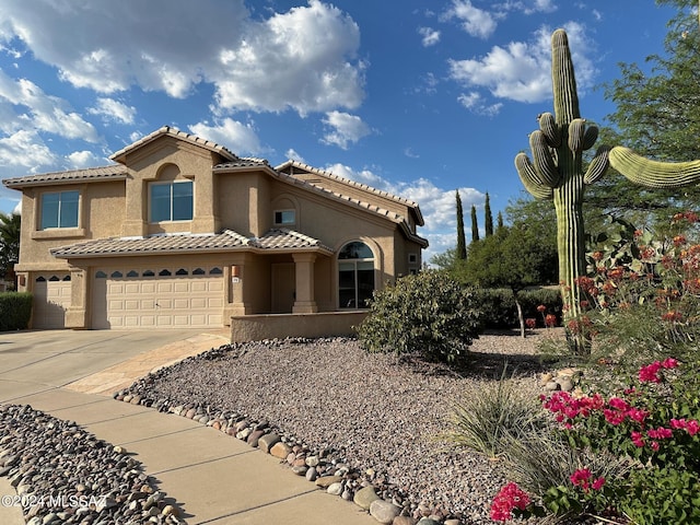 mediterranean / spanish-style home with a garage