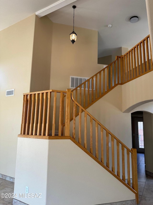 staircase featuring tile patterned flooring