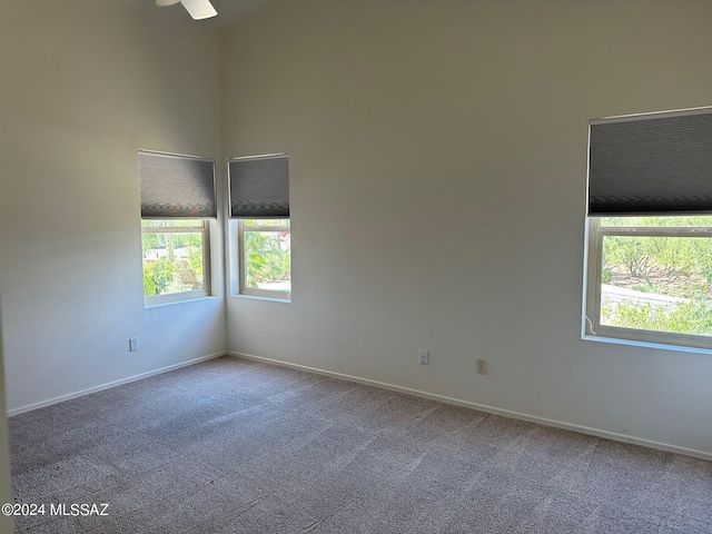 spare room with carpet flooring and ceiling fan