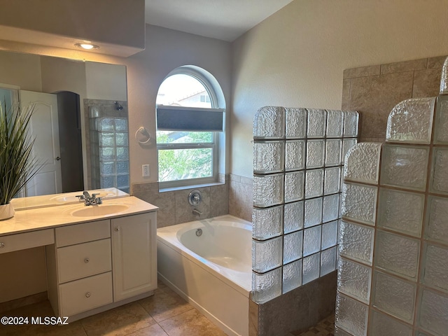 bathroom featuring tile patterned flooring, vanity, and separate shower and tub