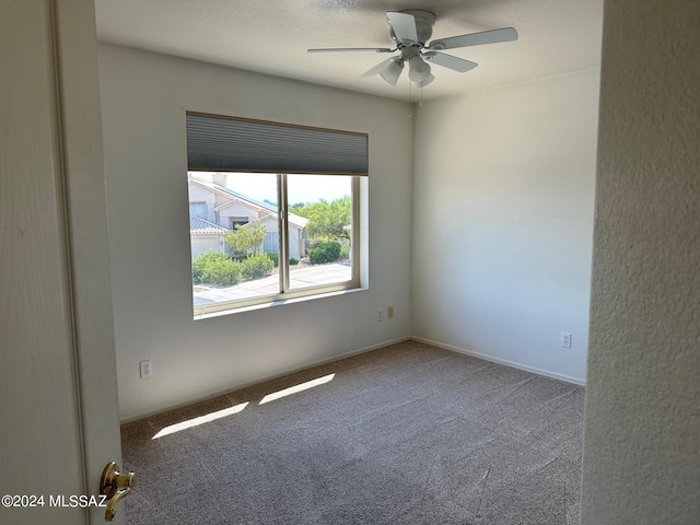 empty room featuring carpet and ceiling fan