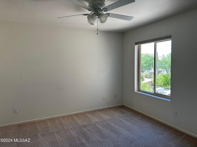 spare room with carpet floors and ceiling fan