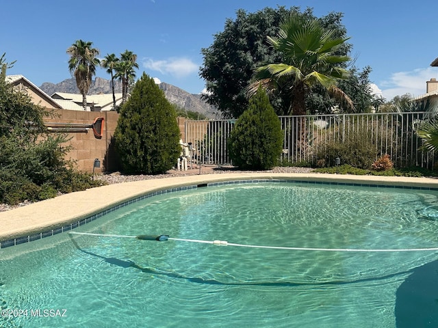 view of swimming pool with a mountain view