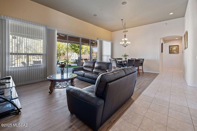 living room with an inviting chandelier and light hardwood / wood-style floors