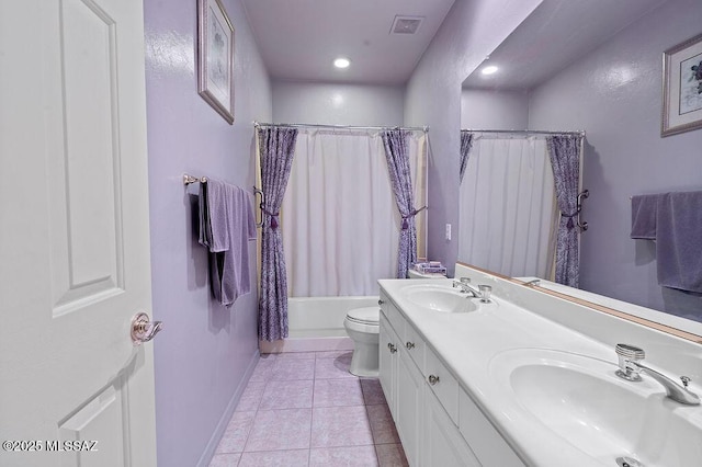 full bathroom featuring tile patterned flooring, toilet, vanity, and shower / bath combination with curtain