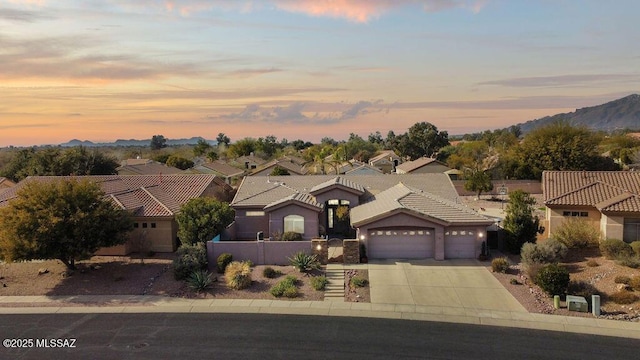 view of front of property featuring a garage and a mountain view