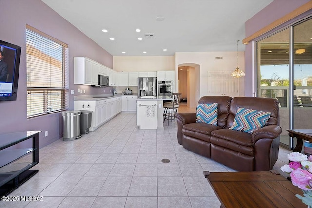 living room with light tile patterned floors and an inviting chandelier