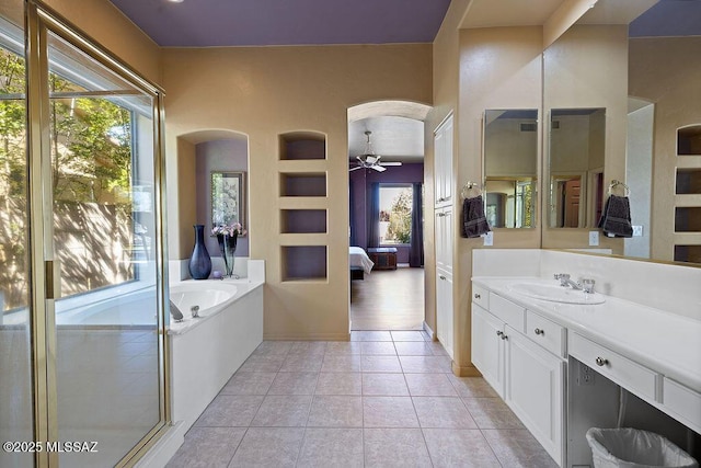 bathroom with tile patterned floors, vanity, built in features, ceiling fan, and plus walk in shower