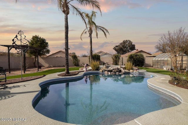 pool at dusk featuring an outdoor structure