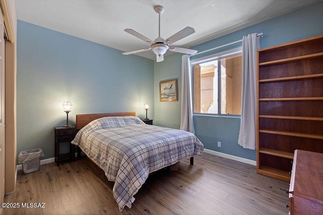 bedroom with ceiling fan and wood-type flooring