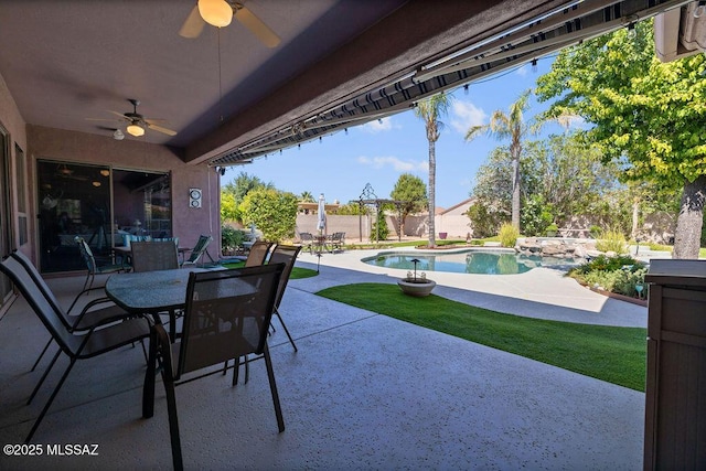 view of patio / terrace with a fenced in pool and ceiling fan