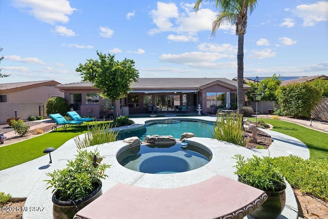 view of swimming pool featuring a patio area and an in ground hot tub