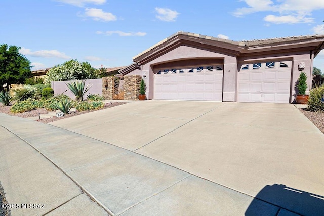 ranch-style house featuring a garage