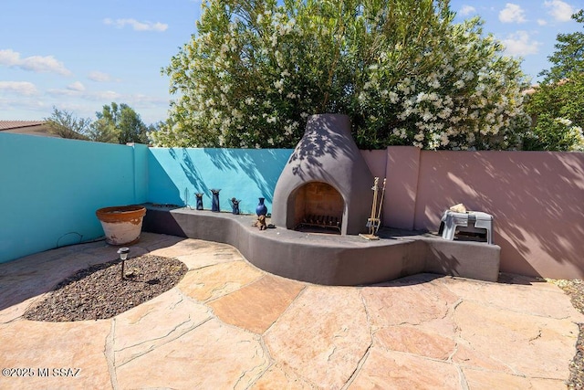 view of patio featuring exterior fireplace