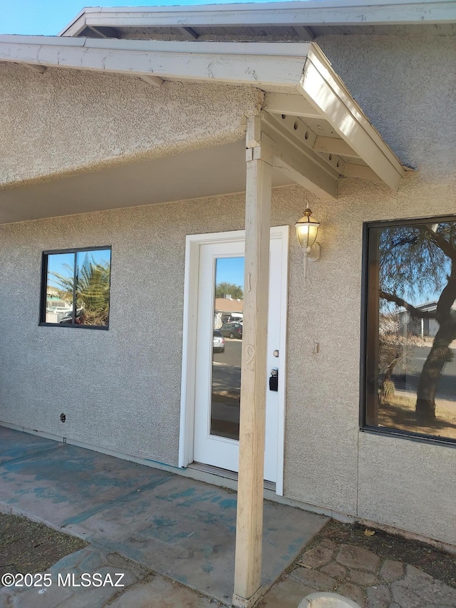 property entrance featuring a patio