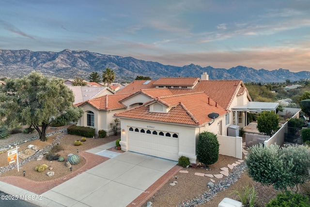 mediterranean / spanish-style house featuring a garage and a mountain view