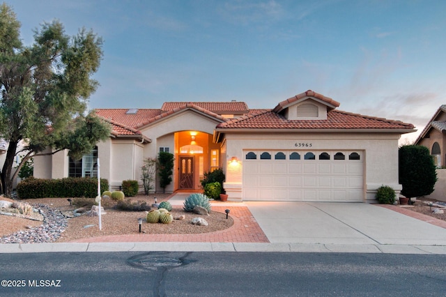 mediterranean / spanish house with a garage