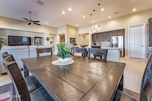 tiled dining space featuring ceiling fan