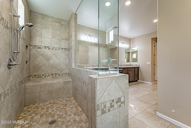 bathroom featuring vanity, tiled shower, and tile patterned floors