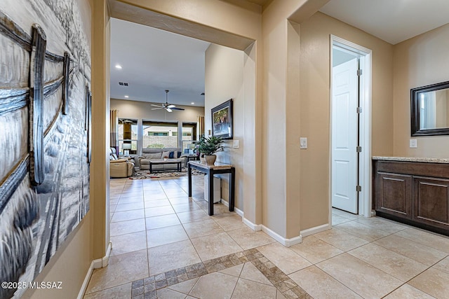 hall with light tile patterned floors