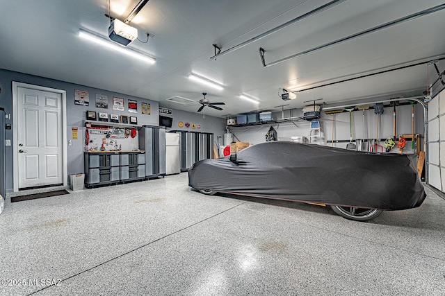 garage with ceiling fan, stainless steel refrigerator, and a garage door opener