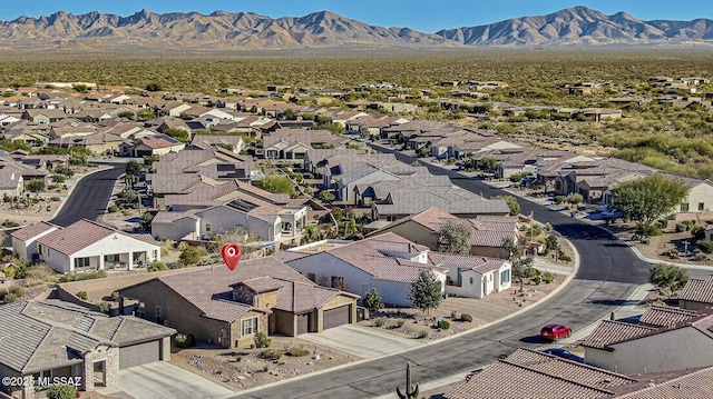 birds eye view of property with a mountain view