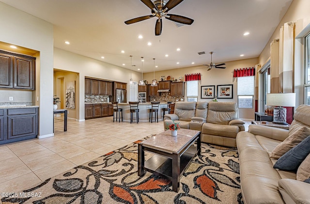 living room featuring ceiling fan and light tile patterned floors