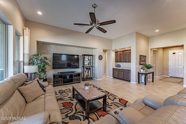 tiled living room with ceiling fan