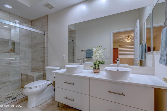 full bathroom with visible vents, a shower stall, and a sink