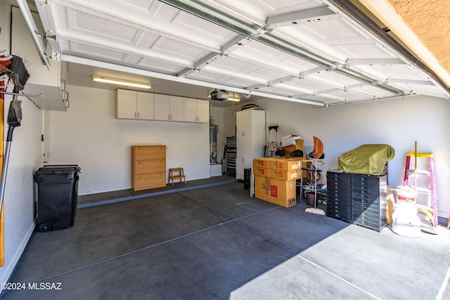 garage featuring gas water heater and a garage door opener