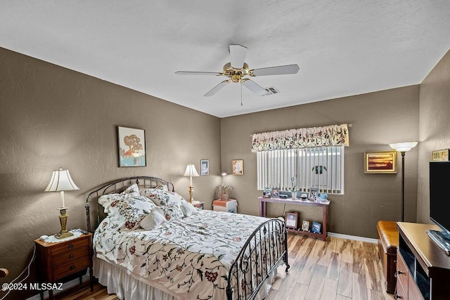 bedroom with ceiling fan and light hardwood / wood-style flooring