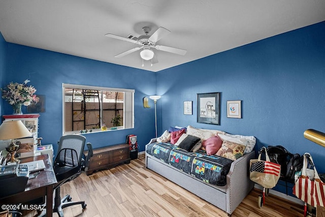 bedroom featuring light hardwood / wood-style floors and ceiling fan