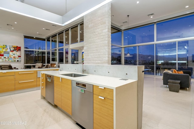 kitchen featuring a wall of windows, dishwasher, a towering ceiling, and sink