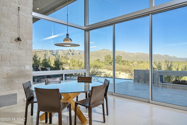 sunroom / solarium with a mountain view