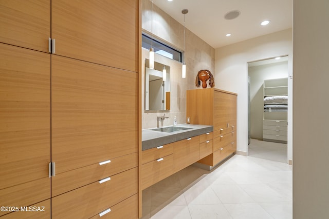 bathroom featuring tile patterned flooring and vanity