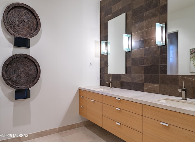 bathroom with tile patterned flooring, vanity, and decorative backsplash