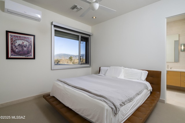 carpeted bedroom featuring ceiling fan, ensuite bath, a mountain view, and a wall mounted air conditioner