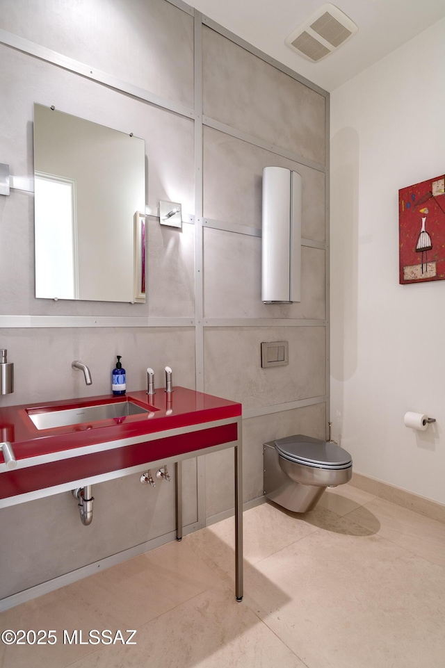 bathroom featuring sink, toilet, and tile patterned flooring