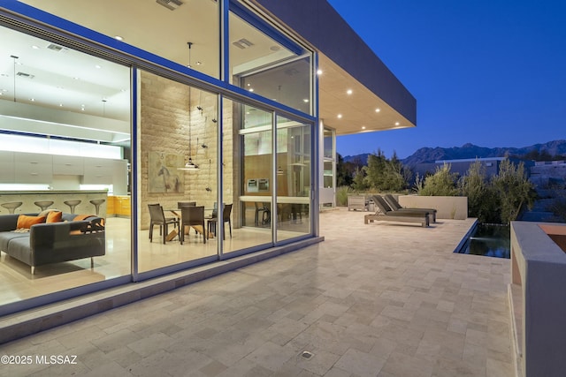 view of patio / terrace featuring a mountain view