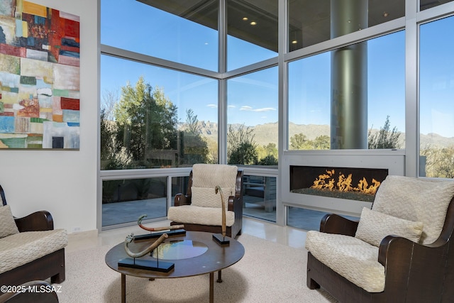 sunroom / solarium featuring a mountain view